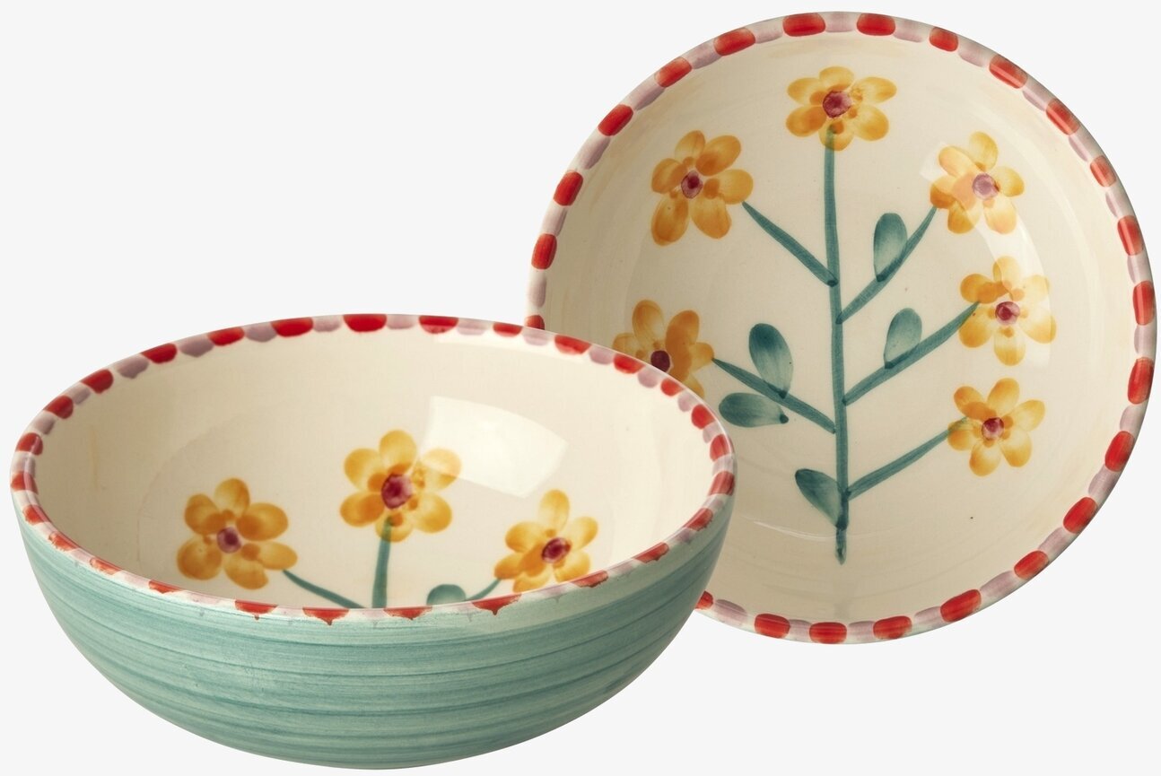 Bild av keramikskålar med blommor och blågrön utsida