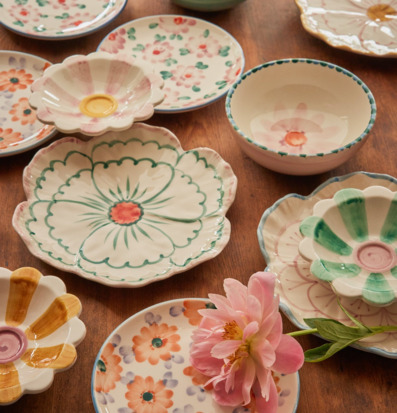 Bild av blomformade keramikskålar i pastell på träbord