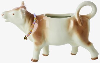 Bild av koformad mjölkkanna med pärlhalsband och klocka