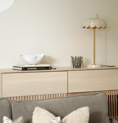 Bild på harmoniskt vardagsrum med stilren lampa och detaljer