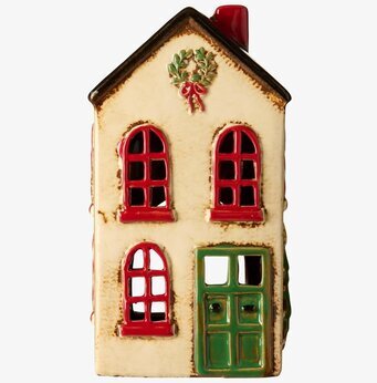 Bild av ljuslykta i keramik med julkrans och röda detaljer