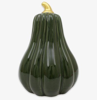 Bild av dekorativ grön pumpa med guldfärgat skaft mot vit bakgrund