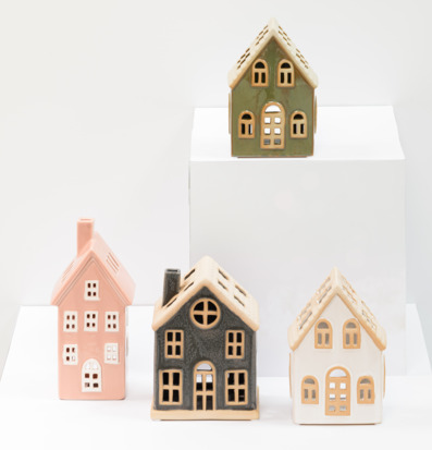 Bild med dekorativa ljuslyktor som små hus i ljus miljö