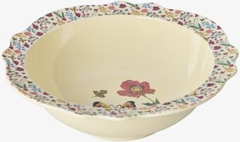 Bild på färgglad skål med blommor och vågig kant i köket