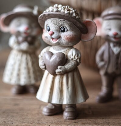 Foto: Musfigur med hjärta på träbord i stillebenmiljö