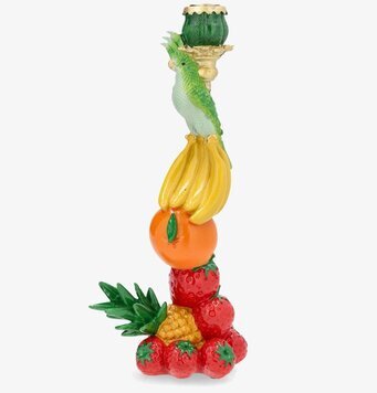 Foto: Ljusstake med frukt och fågel mot vit bakgrund