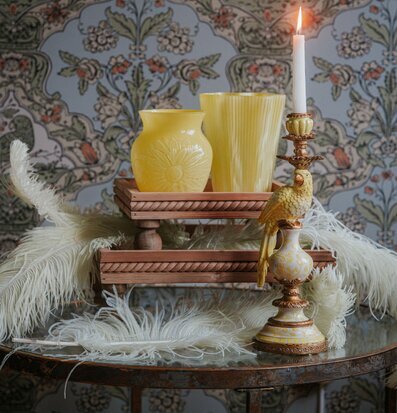 Foto: Stilleben med piedestalbrickor, vas och ljus