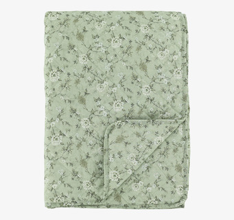 Foto: Quiltad pläd med blommönster i grön/creme