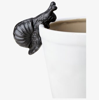 Foto: Svart snigel krukdekoration på vit krukkant