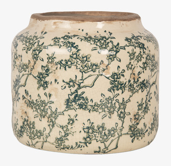 Foto av cremefärgad kruka med grönt blommönster