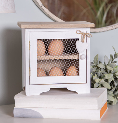 Foto: Litet äggskåp i trä med nät och bruna ägg