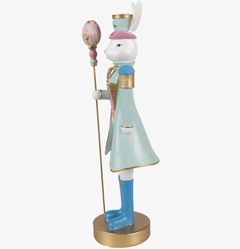 Foto: Kaninfigur i profil med hatt och stav, pastellguld