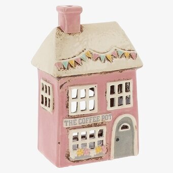 Foto: Rosa keramik huslykta med vimplar och fönster