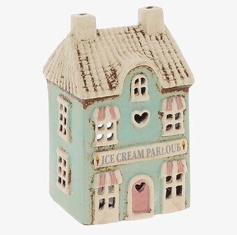 Foto av husformad ljuslykta i keramik, pastellfärger