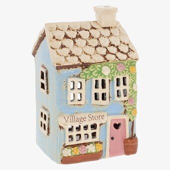 Foto av husformad ljuslykta i blått med fönster