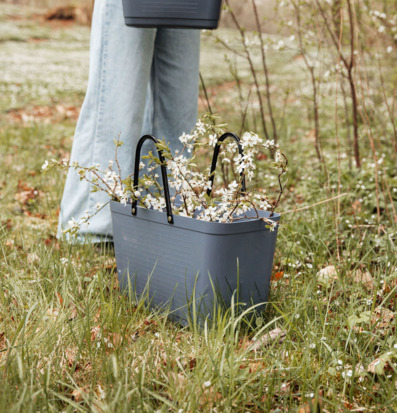 Foto: Duvblå plastväska med vårblommande kvistar