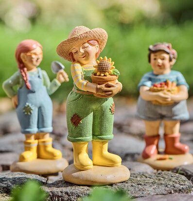 Foto: Trädgårdsfigurer med solros på stenlagd gång