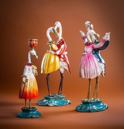 Foto: Flamingodans figurer på turkos sockel, brun bakgrund