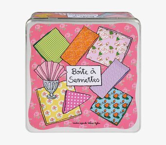 Bild av färgglad plåtburk med livfullt servettmotiv