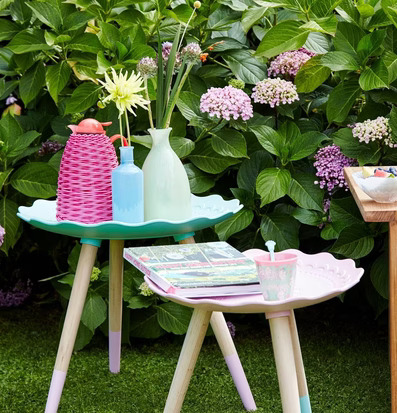 Side Table Mint från Rice i en grönskande trädgårdsmiljö