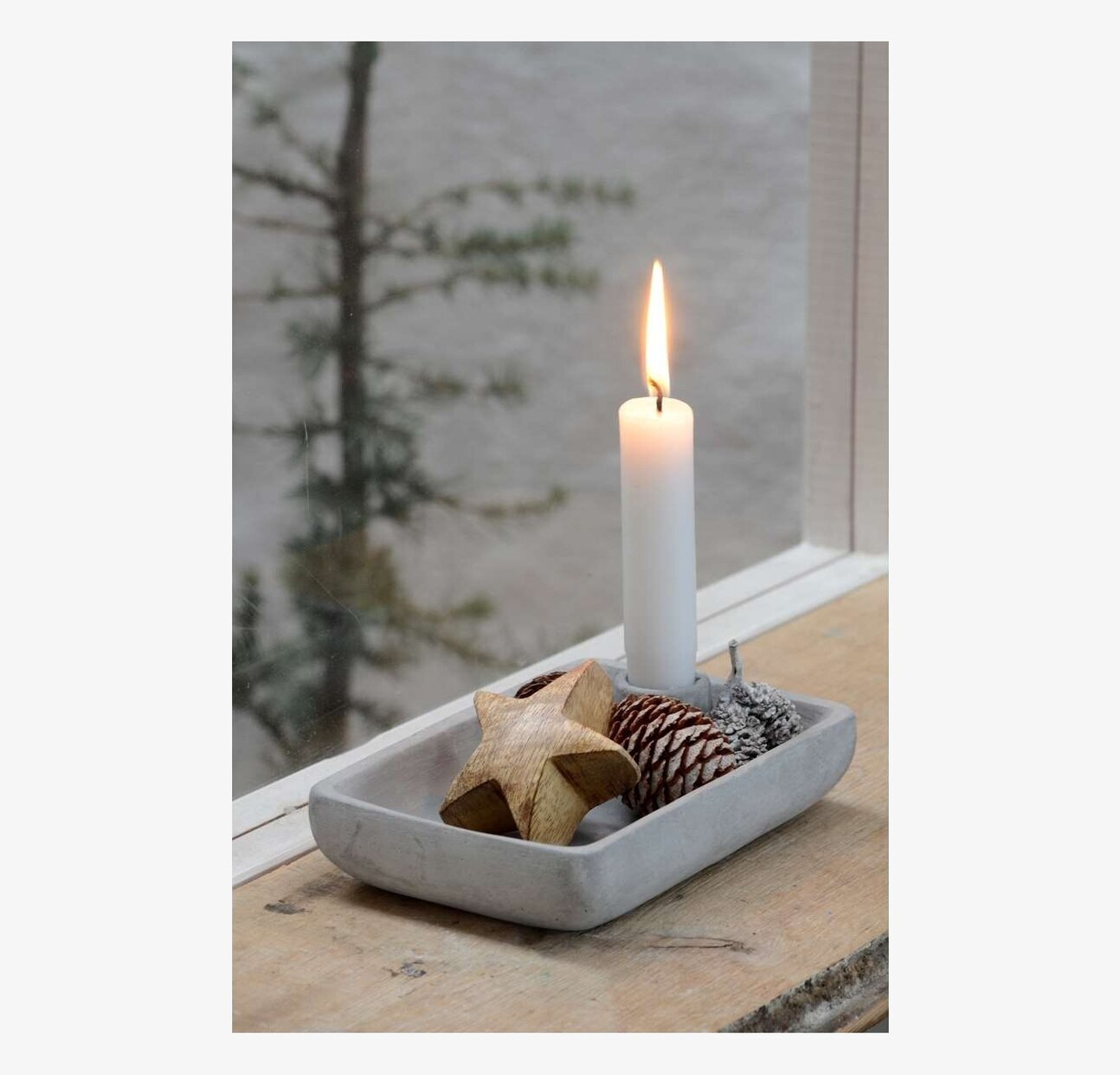 Trästjärna från IB Laursen på betongbricka med ljus och kotte
